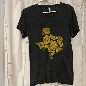 Grey tee with yellow flowers in the shape of Texas